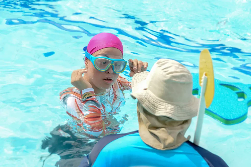 A young disabled woman is learning to swim at the local pool